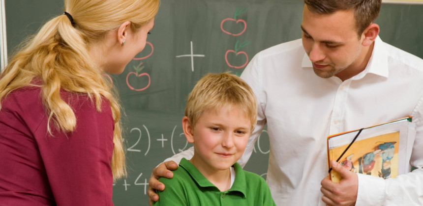 Parents and teacher talking with child