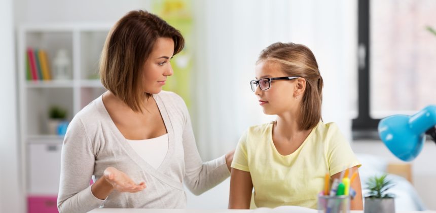 Mother and daughter discussing school grades.