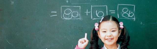 Girl in front of a chalk board with match equations on it