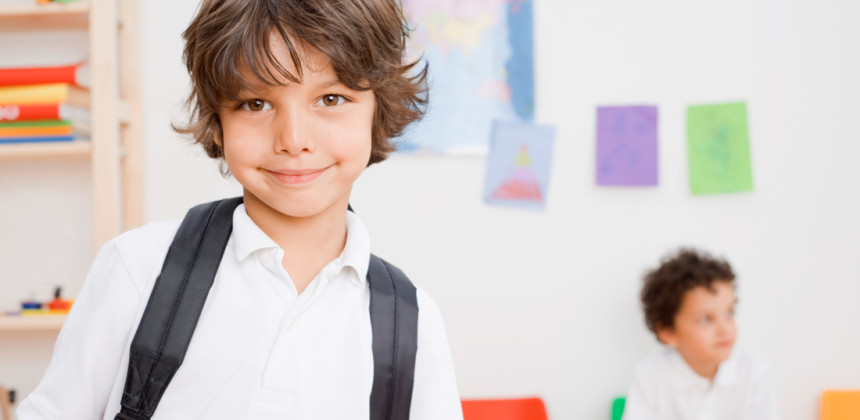 Young boy ready at school with his backpack on