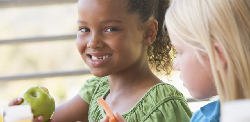 young girl eating an apple