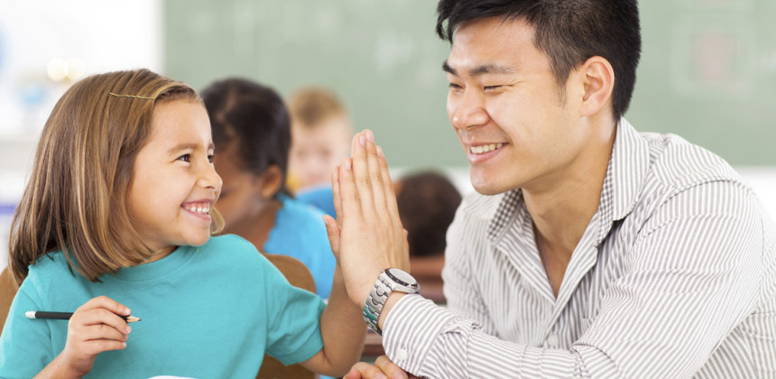 Teach and student high fiving in class