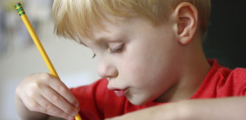 Young boy writing his homework