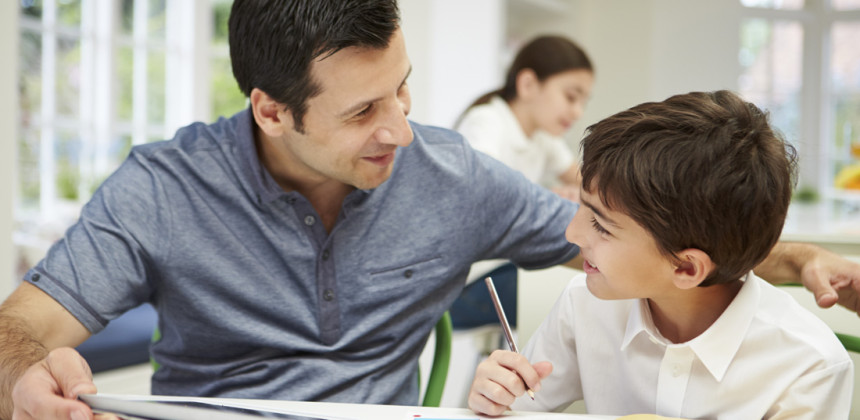 man and boy studying french at home