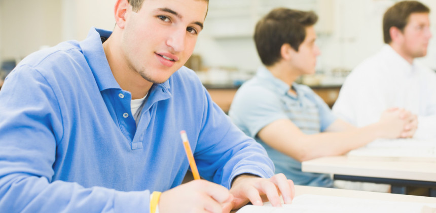 Student reading from paper to study