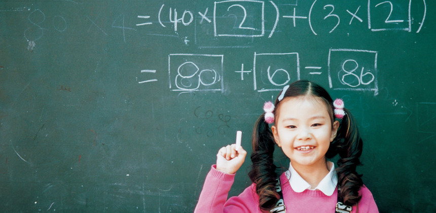 Student at a chalk board understanding math