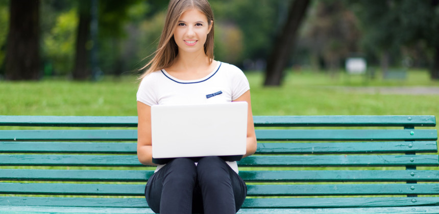 Teenage girl studying on a bench training her brain