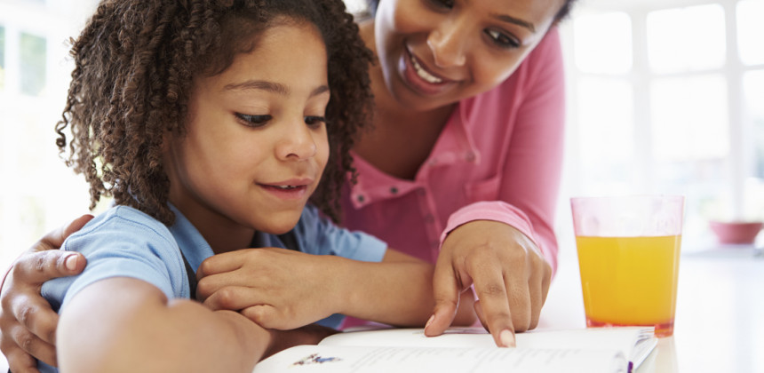 Child learning with her mother at home