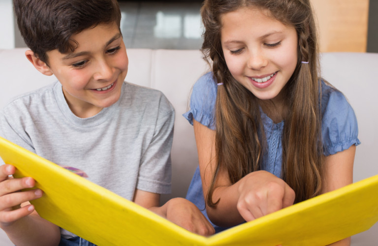 Two children performing a reading activity