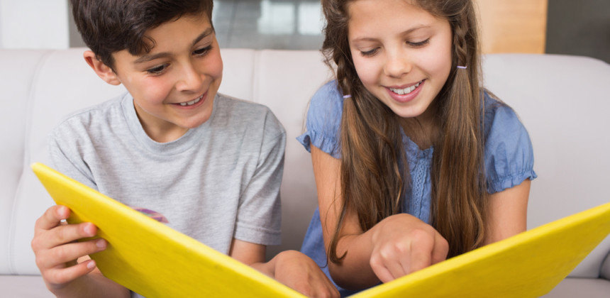 Two children performing a reading activity