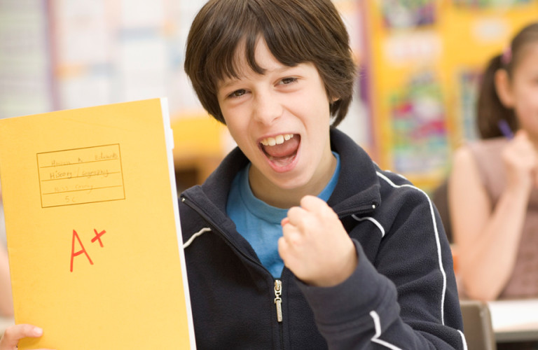 Motivated kid in school receiving his report card