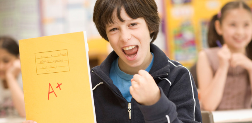 Motivated kid in school receiving his report card
