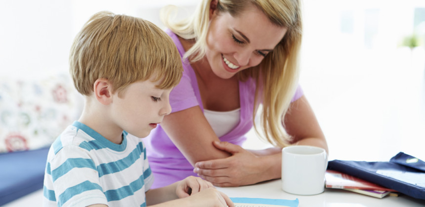 Mother sitting with her young child reading