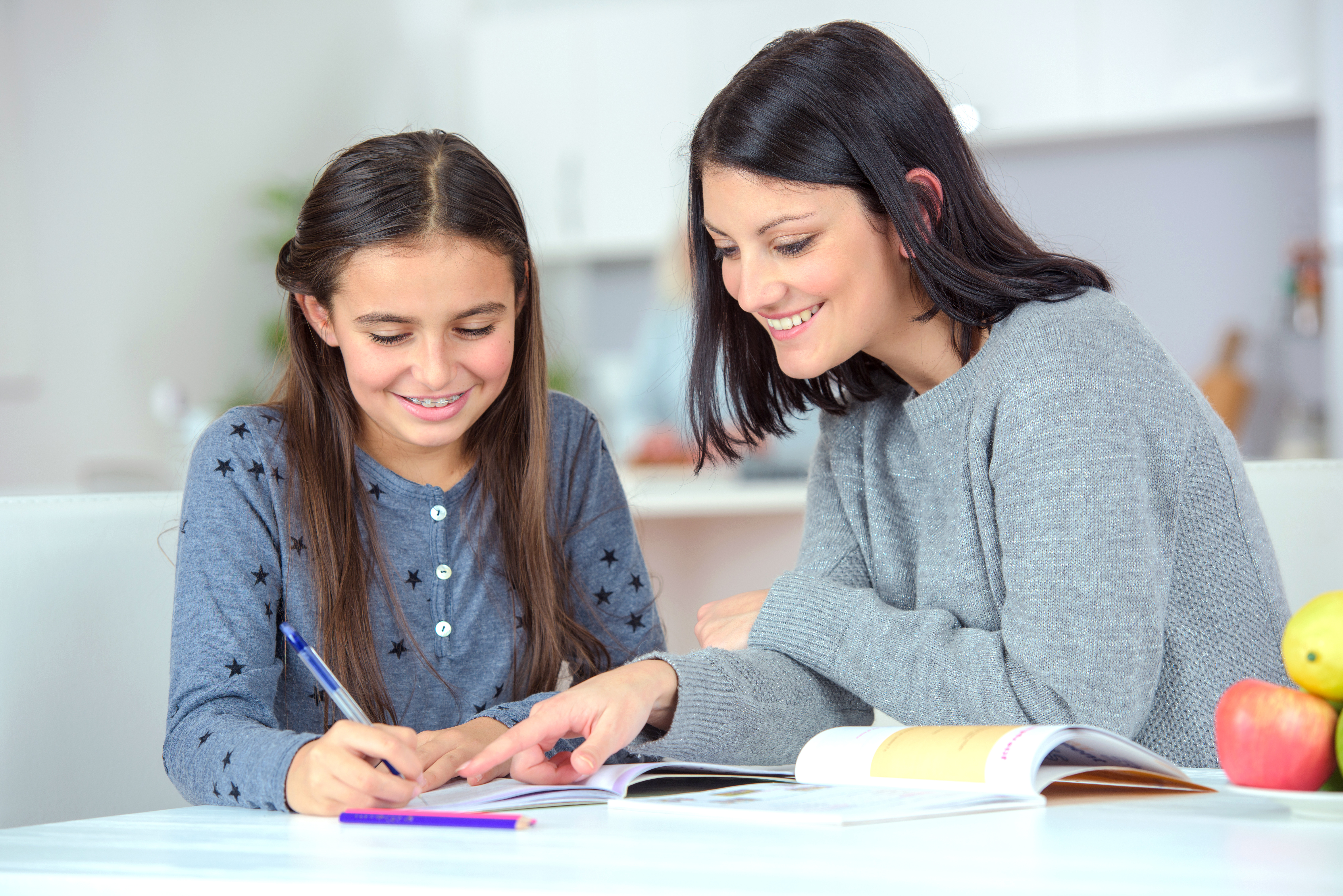 Mom helping her daughter do her homework