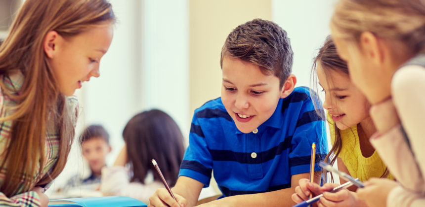 group of students talking and writing at school