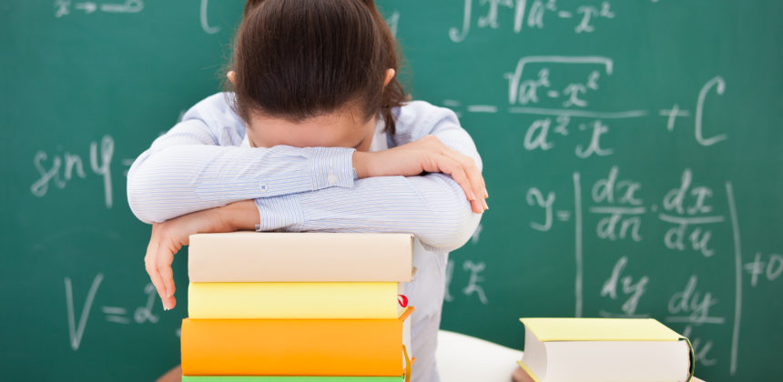 Student With Head Down On Books