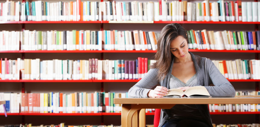 female student studying at library